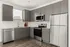 Contemporary kitchen with stainless steel appliances, grey cabinets, and wood flooring, offering a stylish and functional space.