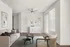 Contemporary living room with modern beige sofa, stylish coffee tables, and chic wall art.