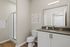 Modern bathroom showcasing sleek design with elegant cabinetry, a spacious countertop, and a stylish walk-in shower.