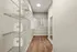 Spacious walk-in closet featuring modern wire shelving, elegant hardwood flooring, and ample storage space.
