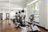Modern fitness center with state-of-the-art exercise equipment and floor-to-ceiling windows for natural light.