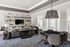 Chic living room with modern decor, stylish shelving, and a sophisticated dining area, perfect for entertaining.