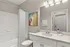 Contemporary bathroom featuring a sleek white vanity, modern lighting, and a vibrant abstract painting.