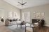 Elegant living room with modern furniture, cozy natural light, and tasteful wall art, ideal for stylish relaxation.