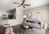 Inviting modern living room with elegant decor, featuring a cozy beige sofa, stylish armchairs, and a sleek open-concept kitchen.