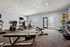 Modern gym facility with sleek workout equipment, including treadmills and exercise bikes, in a bright, spacious room.