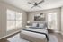 Bright and airy bedroom with elegant decor, featuring a comfortable bed, modern ceiling fan, and large windows allowing abundant natural light.