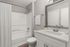 Elegant bathroom featuring a sleek vanity, modern fixtures, and a pristine white bathtub with luxurious accents.