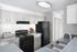 Modern kitchen with sleek countertops, stylish cabinetry, and contemporary appliances including a black stove and refrigerator.