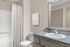 Elegant bathroom with a sleek vanity, large mirror, and soft neutral tones.