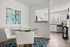 Modern dining area with sleek glass table and elegant white chairs, adjacent to a bright kitchen featuring stainless steel appliances and stylish decor.