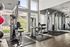 Modern fitness center with premium gym equipment and bright natural lighting.