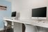 Modern iLounge with sleek Apple computers and minimalist design, perfect for productivity and relaxation.