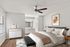 Elegant bedroom with a modern ceiling fan, soft natural light, and chic decor, offering a tranquil retreat.