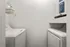 Sleek and efficient laundry nook featuring modern washer and dryer set with stylish shelving.