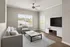 Bright and modern living room with elegant decor, featuring a cozy sofa, stylish armchair, and a large TV for entertainment.