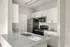 Modern kitchen with sleek quartz countertops, stainless steel appliances, and stylish cabinetry.