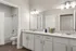 Sleek bathroom design featuring dual sinks, granite countertops, and ambient lighting.