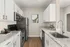 Modern kitchen with sleek stainless steel appliances, elegant white cabinetry, and polished granite countertops.