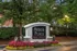 Inviting entrance to Arbor Place Apartments, surrounded by lush greenery and vibrant flower beds, creating a welcoming ambiance.