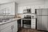 Modern kitchen with sleek stainless steel appliances, white cabinetry, and granite countertops for a stylish and functional cooking space.