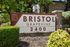 Inviting entrance sign for Bristol Grapevine apartments set amidst lush greenery, emphasizing a welcoming community vibe.