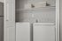 Modern laundry space featuring a sleek washer and dryer set, complemented by organized storage baskets, in a cozy utility nook.