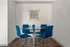 Modern dining nook with a round glass table and vibrant blue chairs, set against a chic geometric artwork.