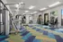 Contemporary fitness center featuring state-of-the-art gym equipment and vibrant patterned flooring.
