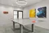 Modern game room featuring a stylish ping pong table, vibrant abstract wall art, and contemporary lighting.