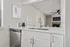 Chic open-concept kitchen with sleek countertops, modern fixtures, and a cozy living area with a fireplace.