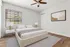 Bright and modern bedroom with a cozy bed, stylish decor, and natural light streaming through large windows.