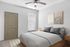 Inviting bedroom with modern decor, featuring a plush bed, elegant artwork, and a ceiling fan for comfort.