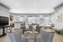 Luxurious open-concept living area with elegant furnishings, stylish decor, and ample natural light through large windows.