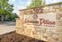Inviting entrance at Lakeside Villas Apartment Homes, featuring charming stone signage under the bright sky.