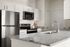 Modern kitchen with sleek stainless steel appliances, elegant countertops, and abundant cabinetry, offering a stylish and functional cooking space.