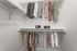 Elegant walk-in closet with neatly arranged clothing on double hanging rods, showcasing ample storage in a bright, modern space.