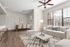 Bright and inviting living space with elegant light decor, featuring a cozy sofa, modern coffee table, and a stylish dining area. Natural light streams in through large windows, highlighting the warm wood flooring and chic patterned rug.