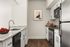 Chic modern kitchen with granite countertops, stylish stainless steel appliances, and elegant hardwood flooring.