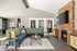Inviting living room with a stylish stone fireplace, modern sectional sofa, and sleek decor, perfect for cozy gatherings.