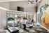 Modern fitness center with large windows, state-of-the-art exercise equipment, vibrant wall art, and a view of the pool.