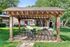 Charming pergola in a lush garden setting with a modern outdoor grill and cozy seating area, ideal for relaxation and entertaining.