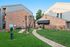 Inviting apartment complex exterior with a designated pet area and green space, perfect for pet owners and outdoor relaxation.