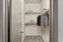 Spacious walk-in closet with neatly organized shelving and hanging space, perfect for stylish storage solutions.