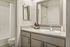 Modern bathroom with sleek fixtures, elegant mirror, and ample countertop space for a spa-like ambiance.