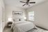 Inviting bedroom with a cozy double bed, elegant striped bedding, and warm natural light.