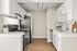 Bright, modern kitchen with sleek stainless steel appliances, white cabinetry, and elegant wood flooring creating a warm and inviting space.