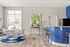 Bright and modern dining area with elegant chairs around a stylish table, complemented by a vibrant blue accent wall and sleek breakfast bar.