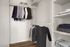 Spacious walk-in closet showcasing organized clothing racks and shelves, perfect for stylish storage solutions.