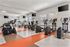 Modern fitness center with state-of-the-art exercise equipment and bright natural lighting.